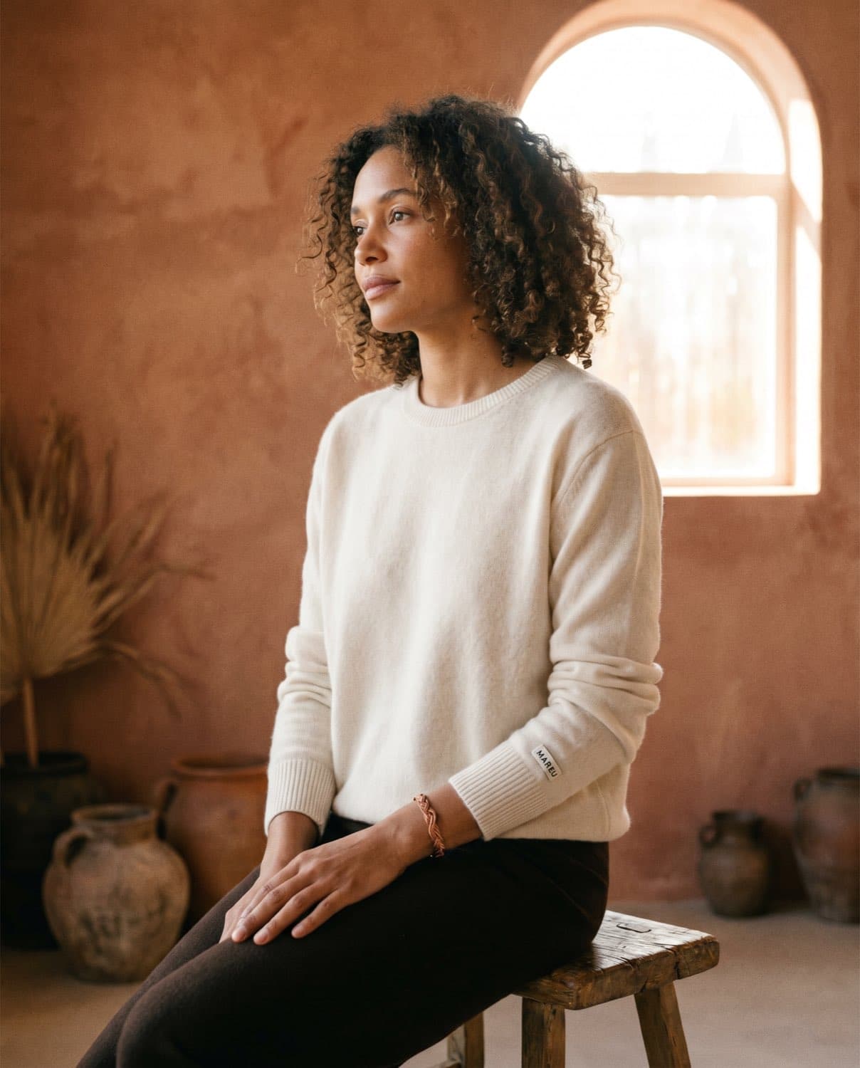 Lookbook-Bild 2 — Portrait in Cashmere-Strick vor Bogenfenster
